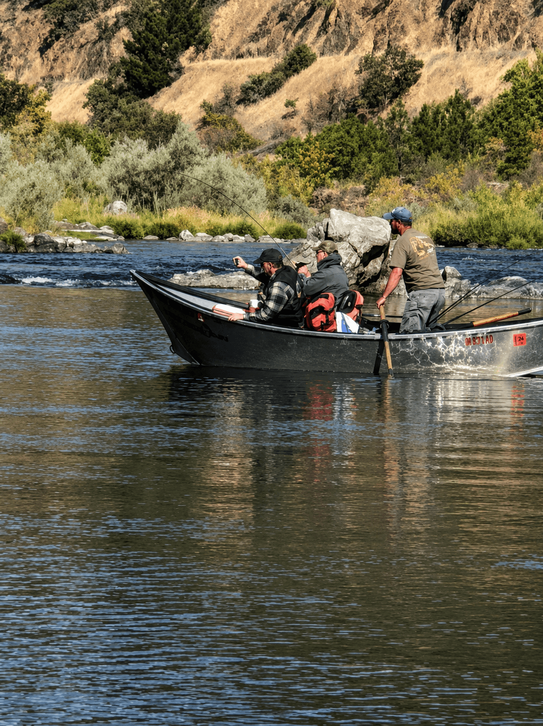Gabe Lambert rowing the drift boat while clients fish a Southern Oregon river